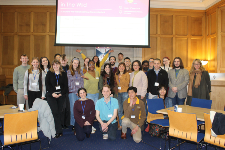 PhD students and staff pose for a photo in Parliament Hall, St Andrews